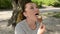 Young charming girl eats chocolate ice cream