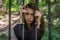 Young charming girl the teenager with long hair sitting behind bars in prison prisoner in a medieval jail with sad, pleading eyes