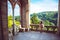 Young charming lady in vintage dress on the balcony of the castle