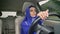 Young charming muslim woman in hijab driving a car on the road