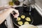 Young charming Swedish woman cooking at home in her kitchen, preparing healthy mediterranean food for her family. Young food