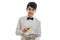 Young charming waiter looks straight smiles and holds a tray with two glasses of wine