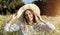 Young Charming Woman in Hat on Flowery Lawn