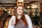 Young charming woman plus size with milkshake in hand in cafe, enjoing life and appearance