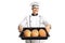 Young cheerful baker holding a tray of bread loafs