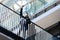 Young and cheerful businessman in suit raised hand up on urban background. Success and victory, positive lifestyle. Award, winner