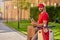 Young cheerful caucasian man courier delivering paper packet