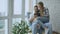 Young cheerful couple talking and using tablet computer on balcony in modern loft apartment