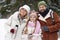 Young cheerful couple and their pretty pre-teen daughter in winterwear
