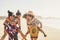 Young cheerful couples enjoy the beach and ocean in summer holiday vacation tourism - happy tourist enjoy fuerteventura paradise