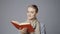 Young cheerful female reading a book