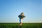 Young cheerful girl with blond hair with a basket of lilacs. Summer moment. blonde girl in a white dress and a nice hat holds a