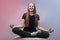 Young cheerful girl meditates. Yoga lessons. Funs yoga woman