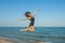 Young cheerful girl on the sea