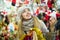 Young cheerful happy woman choosing Christmas decoration