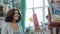 Young cheerful model African American woman posing for group of arts students in studio