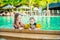 Young cheerful mother and son in a swimming pool