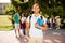 Young cheerful mulatto male nerdy student is standing with a not