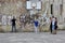 Young cheerful people paint graffiti on the wall under the basketball basket