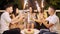 Young cheerful people sitting in cafe at night with firework sparklers.