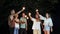 Young cheerful people sitting on the weekend at night with firework sparklers.