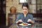 Young cheerful woman on lunch at restaurant