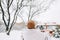 Young cheerful woman tosses a handful of snow up, having fun enjoying wintertime