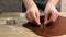 A young chef carves the shape of a heart on a gingerbread dough using iron