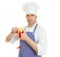 Young chef cook pealing apple.