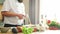 Young chef fries salmon fish with a gas burner in a modern kitchen. The man prepares food at home. Cooking healthy food.