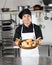 Young Chef Holding Basket Of Breads