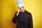 Young chef man wearing uniform and hat standing over isolated yellow background tired rubbing nose and eyes feeling fatigue and