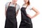 Young chefs or waiters man and woman posing, wearing aprons on white background.