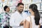 Young Chemist Assisting Female Customer