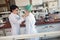 Young chemistry students are putting on protective gear while preparing for a work in a laboratory. Science, chemistry, lab,