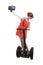 Young chic tourist woman taking selfie photo with mobile phone while riding on segway