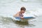 Young child with a bodyboard on the beach