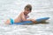 Young child with a bodyboard on the beach