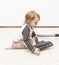 Young child cleaning vacuum cleaner