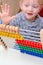 Young child counting with an abacus