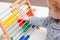 Young child counting with an abacus