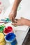 Young child doing finger art with colorful paints