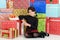 Young child leaning on christmas presents