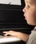 Young child learning to play the piano