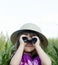 A young child looking through binoculars