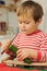 Young child peeling cucumber