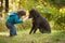 Young child playing fetch with dog