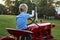 Young Child pretending to drive the red antique tractor