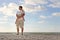 Young Child Resting in Father\'s Arms on Beach by Ocean