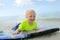 Young Child Riding on Boogie Board in Ocean